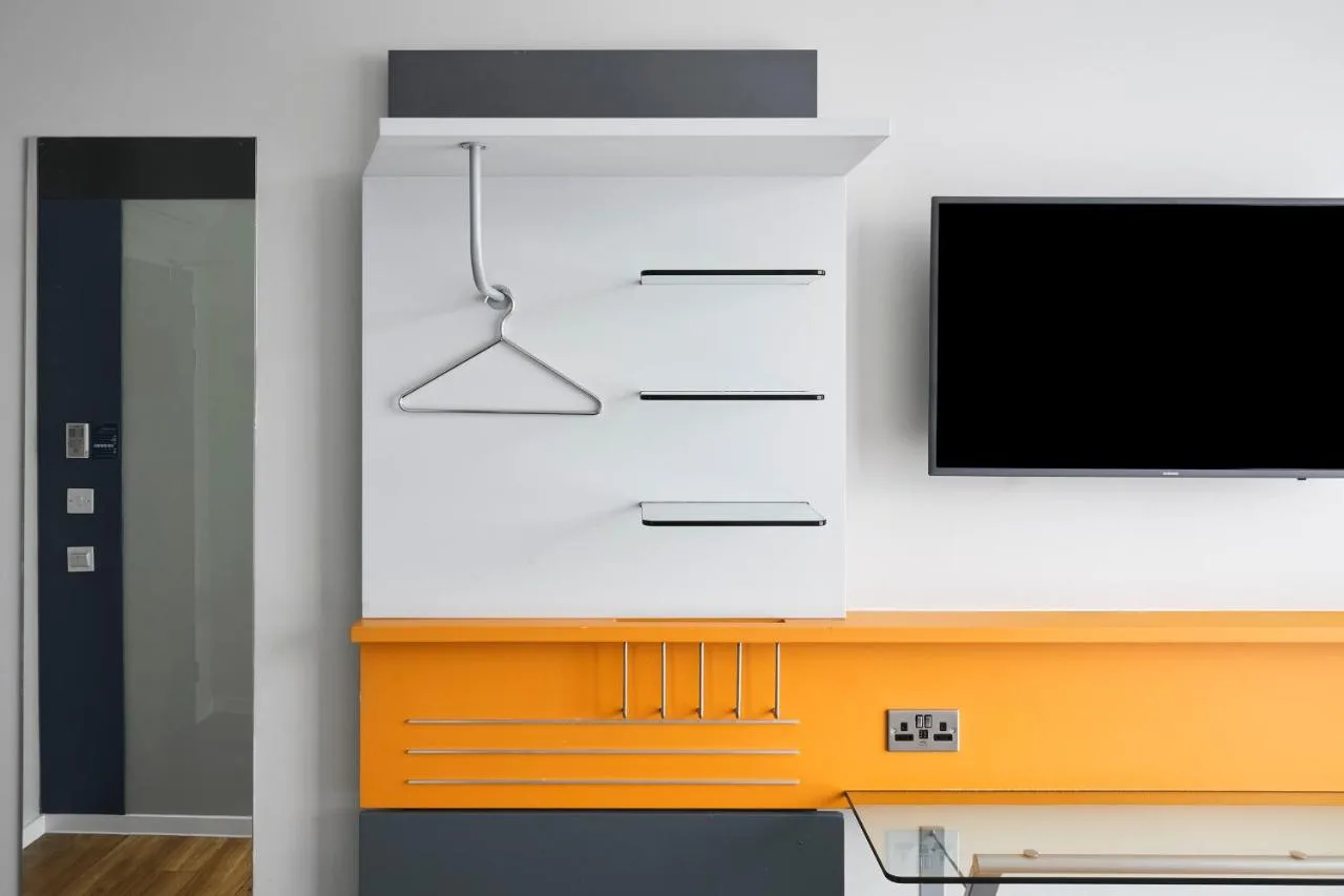 Guest room with a desk and television
