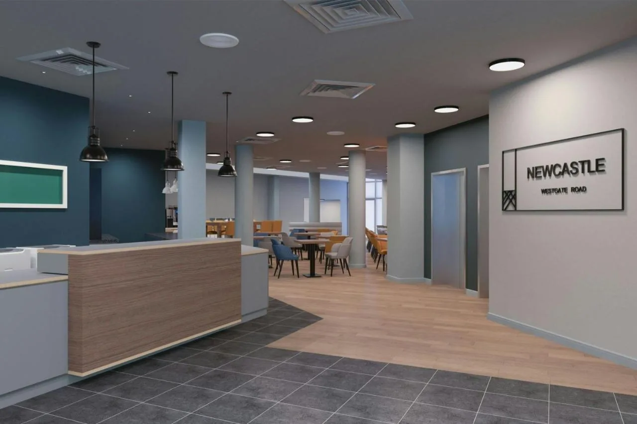 Bright lobby seating area with tables and chairs